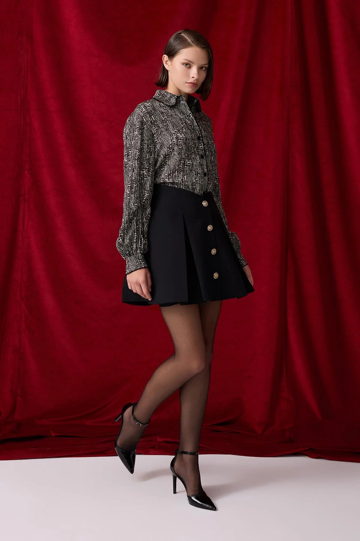 Pleated black skirt with gold buttons
