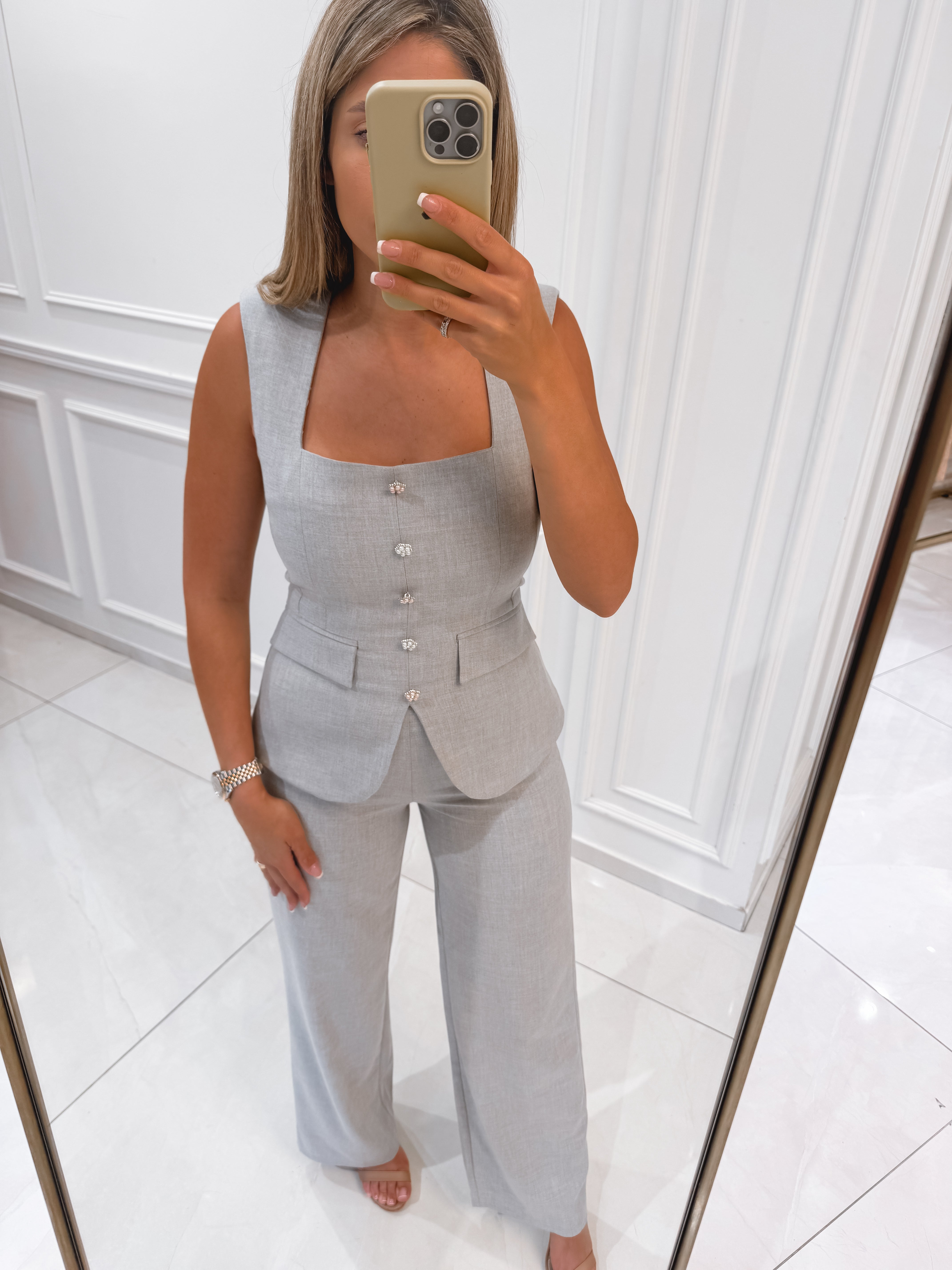 Suit with pearl buttons
